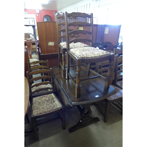 328 - An oak drop leaf table and four ladderback chairs