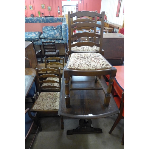 328 - An oak drop leaf table and four ladderback chairs