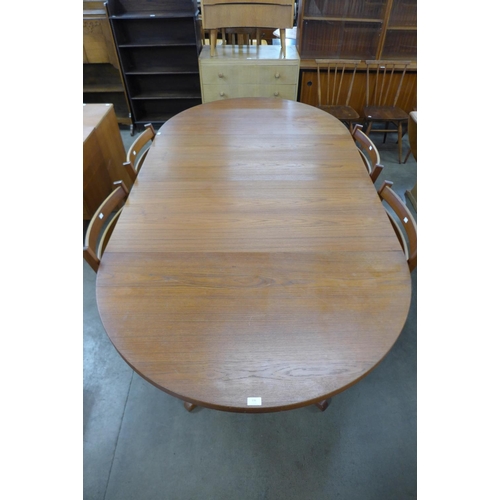 136 - A Danish teak extending dining table and four chairs