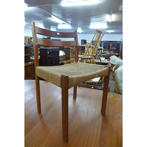 136 - A Danish teak extending dining table and four chairs