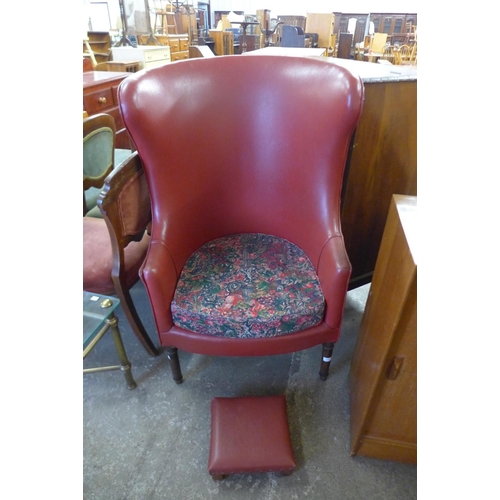 222 - A George III style mahogany and faux red leather armchair and footstool