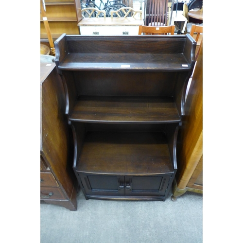 235 - An Ercol dark open bookcase