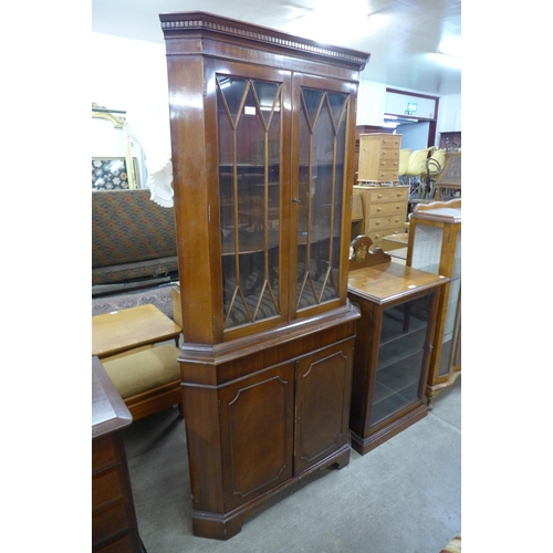 241 - A mahogany freestanding corner cabinet