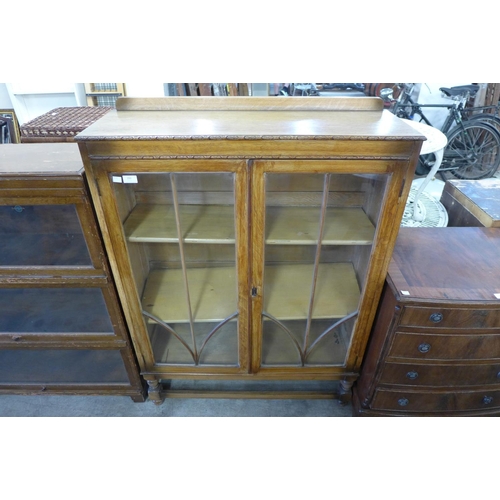 293 - A carved oak display cabinet