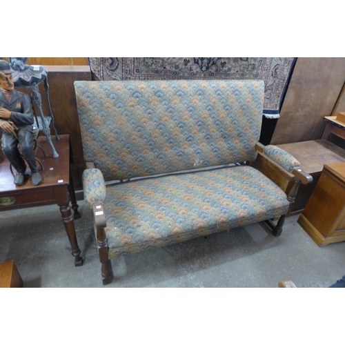 312 - A 1930's oak and upholstered settle