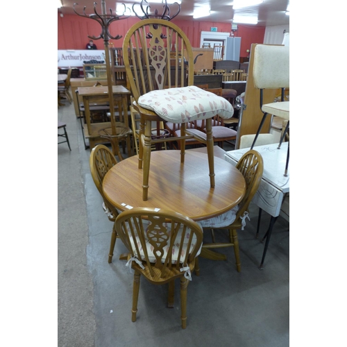 319 - A beech circular kitchen table and four chairs