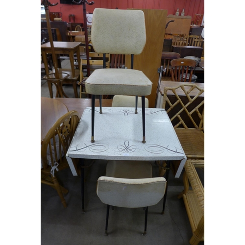 321 - A Formica kitchen table and three chairs