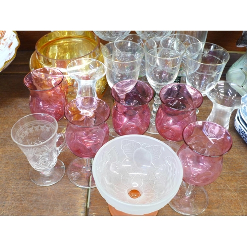 675 - A collection of drinking glasses; five cranberry glasses, four long stemmed glasses, etched glasses,... 