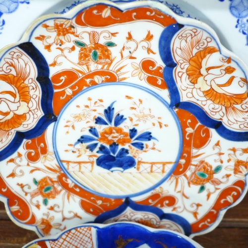 689 - Three Imari plates, other plates and an Ironstone bowl