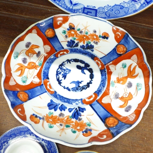 689 - Three Imari plates, other plates and an Ironstone bowl