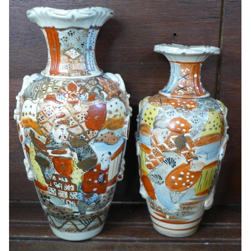 702 - A collection of 20th Century Meiji revival period china comprising three vases decorated with samura... 