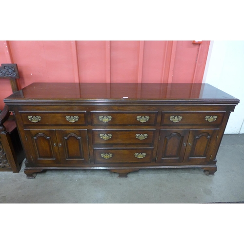 68 - A George III style oak and mahogany crossbanded dresser, 88cms h, 200cms w, 55cms d