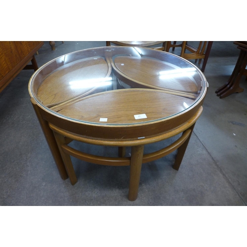 96 - A Nathan teak and glass topped circular nest of tables