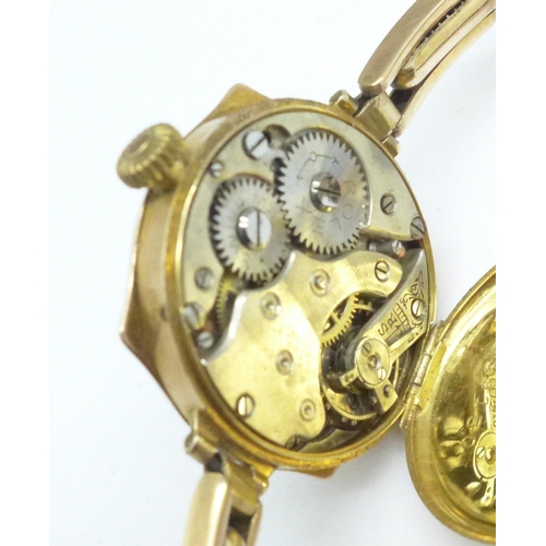 1010 - A lady's Art Deco Rolex watch, movement and case stamped Rolex, 9ct gold case and strap, 22.3g gross... 