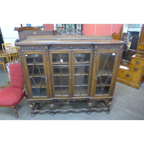 157 - An early 20th Century carved oak four door breakfront bookcase