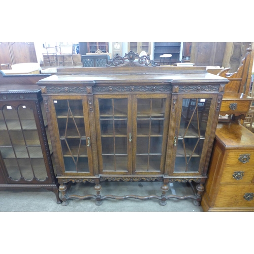 157 - An early 20th Century carved oak four door breakfront bookcase