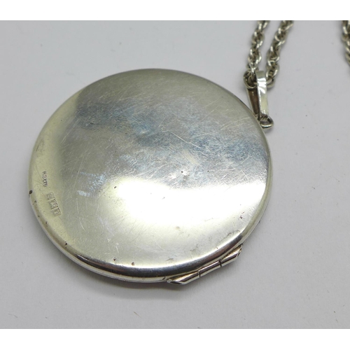 1037 - A silver locket and chain, 18g