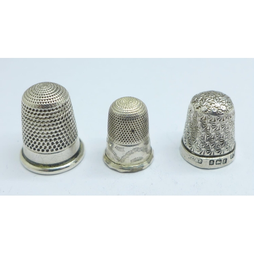 1061 - A Victorian silver thimble by George Unite, Birmingham 1886 and two others, one hallmarked and one t... 