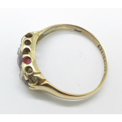 1129 - A 18ct gold, garnet and diamond ring, 2.9g, O