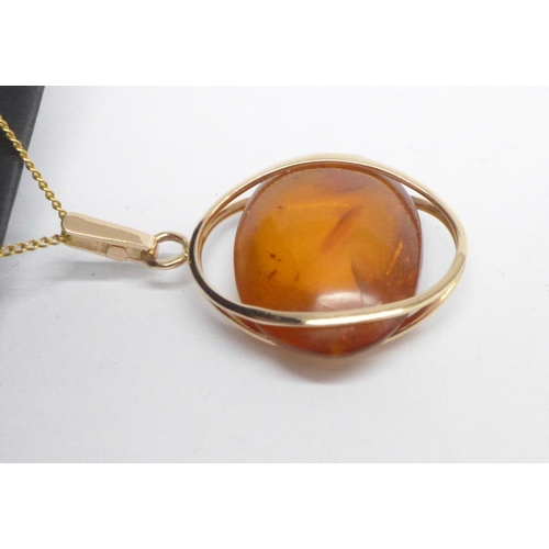 1137 - An amber and yellow metal pendant on chain, marked 583, 6.6g