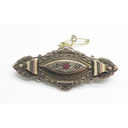 1138 - A 9ct gold, ruby and diamond brooch, with steel pin, 4.1g, cased