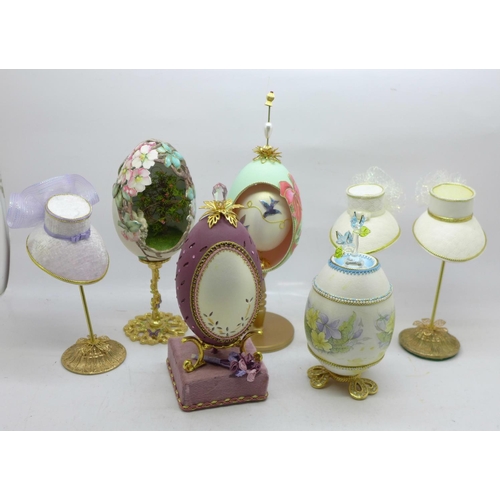 619 - Three decorative goose eggs and three hats on stands