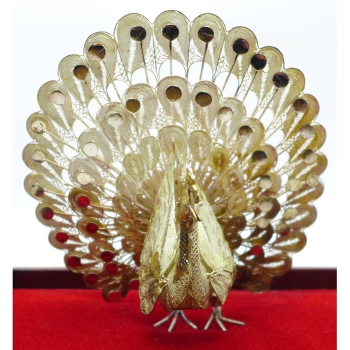 623 - A .925 silver peacock in display case, 12cm