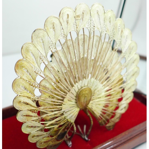 623 - A .925 silver peacock in display case, 12cm