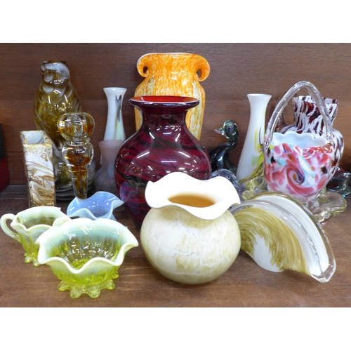 669 - A large collection of coloured glass vases, including Murano, paperweights and bowls