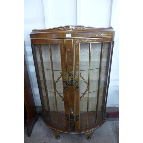 205 - A Japanned walnut bow fronted display cabinet