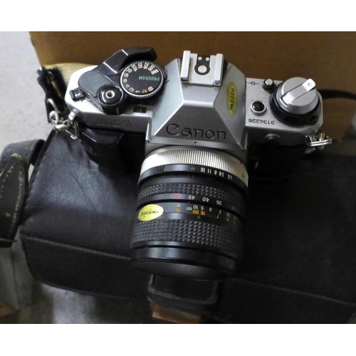 722 - A Canon AE-1 camera with box and other camera equipment, a Printflex Zoom lens, other lenses and two... 