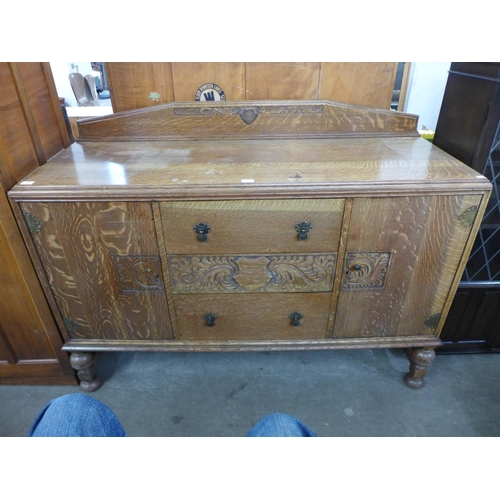 281 - A carved oak sideboard