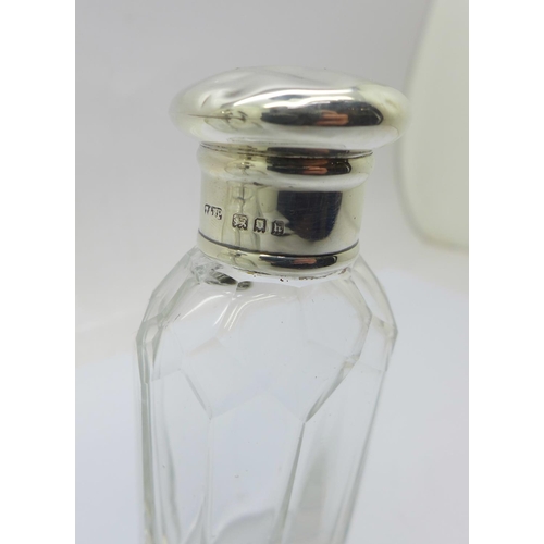 823 - A silver top glass scent atomiser and a silver top scent bottle