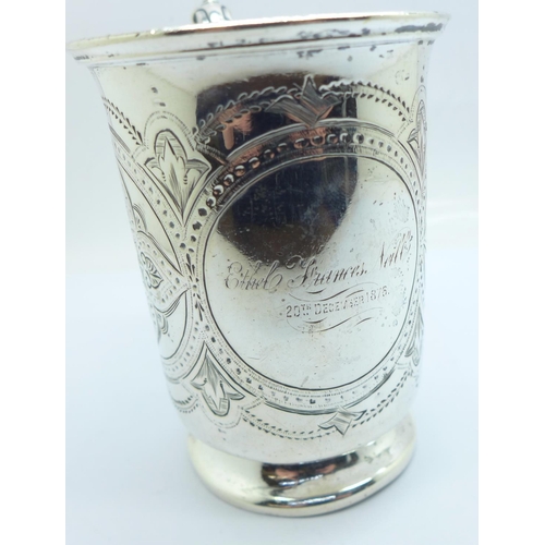 831 - A Victorian embossed silver mug, with inscription dated 1876, London 1874, 187g