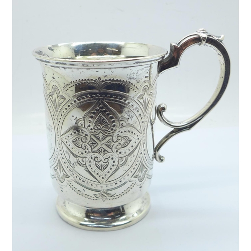 831 - A Victorian embossed silver mug, with inscription dated 1876, London 1874, 187g