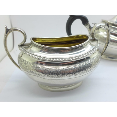 833 - A three piece silver tea service, London 1878, 604g