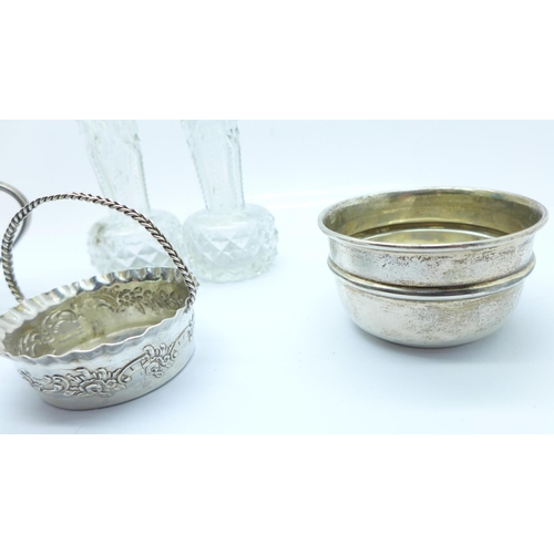 842 - A silver cup, two silver bowls and two silver rimmed glass vases, weight of silver, 118g