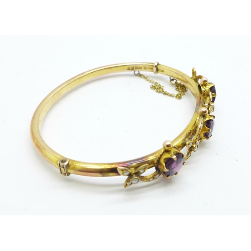 854 - An Edwardian 9ct gold, amethyst and seedpearl bangle, Chester 1907, in original Brittain, Mansfield ... 