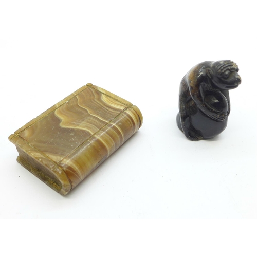 861 - A carved stone figure of a chimpanzee holding a nut and a carved agate Bible