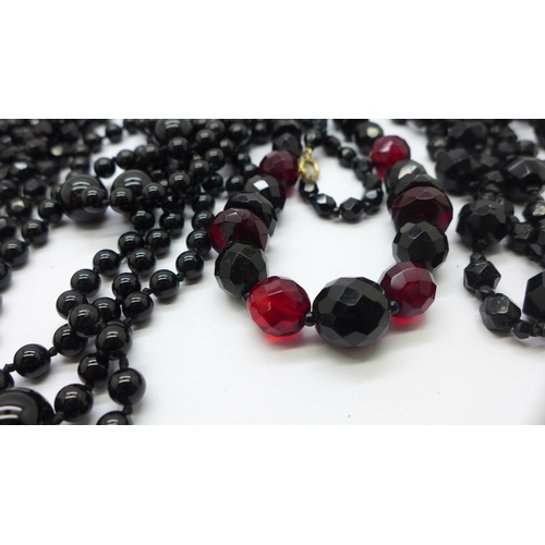 873 - Seven black glass bead necklaces