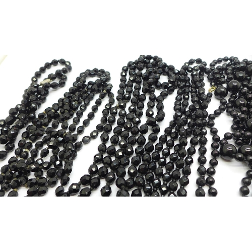 873 - Seven black glass bead necklaces