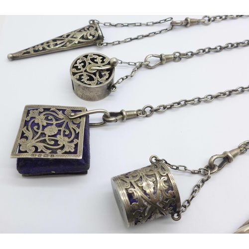 879 - A late Victorian silver chatelaine, clip and pencil with London marks, the four other attachments ha... 