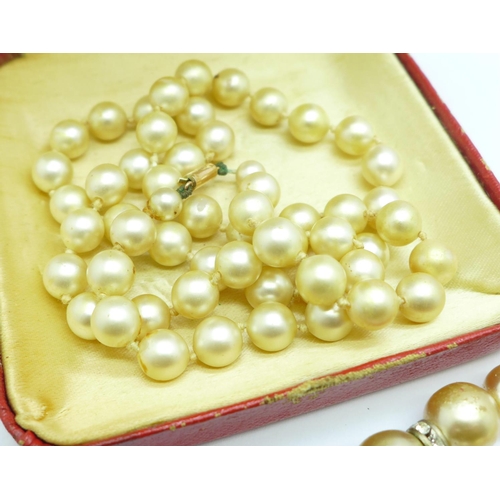 903 - A faux pearl necklace with 9ct gold clasp and other faux pearl necklaces