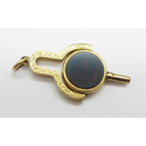 956 - Watch key/fob with onyx stone (tests as 9ct gold), 4.9g