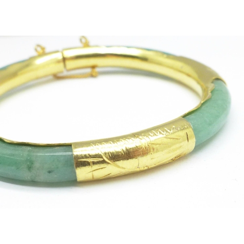 963 - A gilt metal and jade bangle