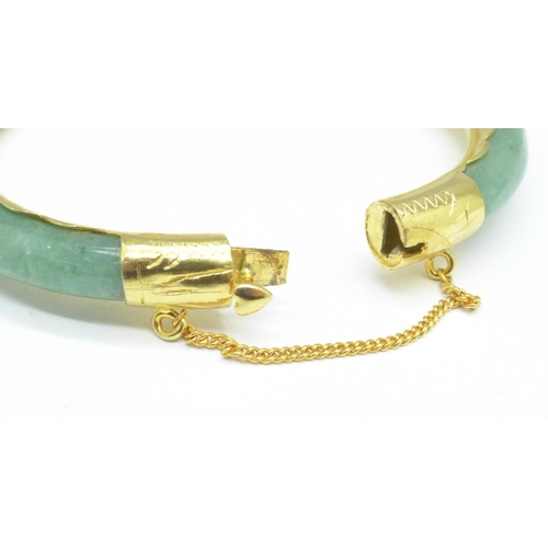 963 - A gilt metal and jade bangle