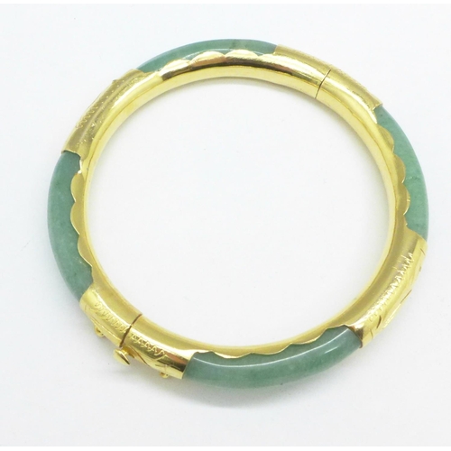 963 - A gilt metal and jade bangle