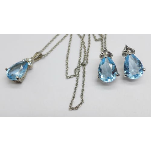 979 - A blue and white stone pendant and earring set