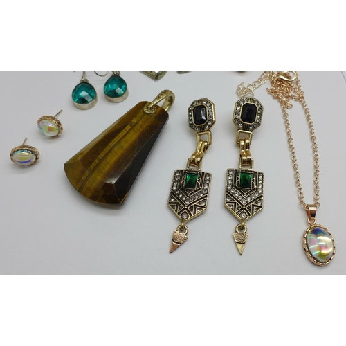 984 - A large tiger's eye pendant, three pairs of earrings and a jewellery set