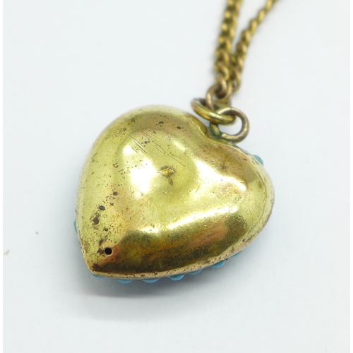 986 - A turquoise set heart shaped pendant on a plated chain